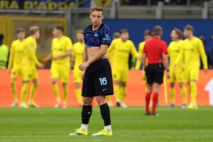 Davide Frattesi dell'Inter deluso con alle sue spalle sullo sfondo i calciatori del Bodo Glimt festanti.